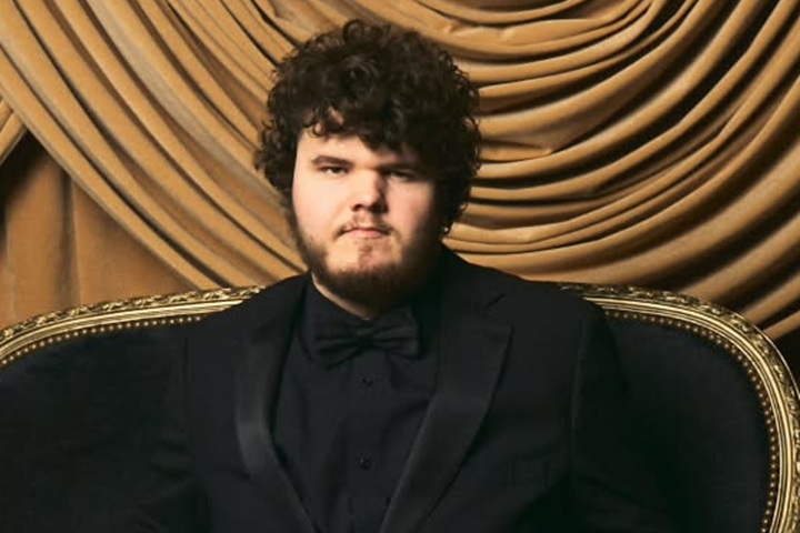 Aidan Delbis smiling on set, rising Hollywood actor with autism and disability, known for Bugonia.