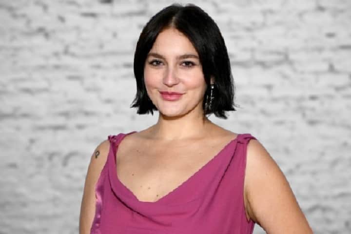 Gracie McGraw smiling confidently at a Pride Month event, showcasing her queer identity and rising career as an actress and singer.